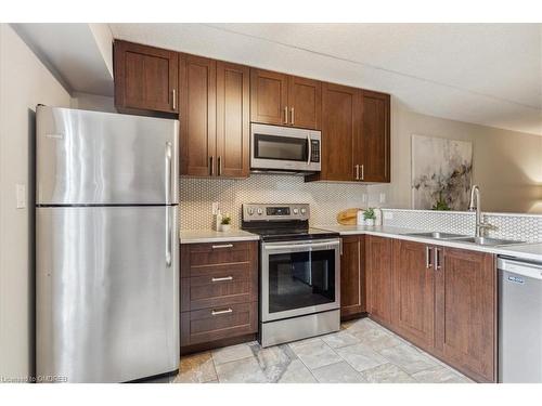 305-4005 Kilmer Drive, Burlington, ON - Indoor Photo Showing Kitchen With Double Sink