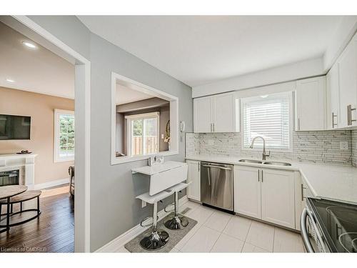 39-2022 Atkinson Drive, Burlington, ON - Indoor Photo Showing Kitchen With Fireplace With Double Sink