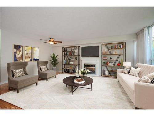 104-1071 Queens Avenue, Oakville, ON - Indoor Photo Showing Living Room With Fireplace