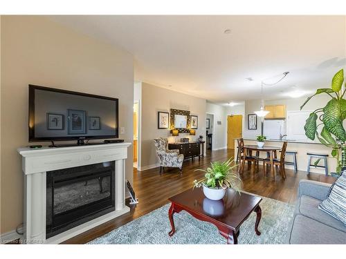 212-383 Main Street E, Milton, ON - Indoor Photo Showing Living Room With Fireplace