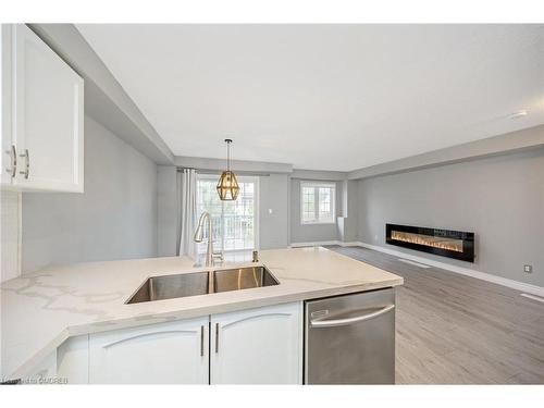 100-620 Ferguson Drive, Milton, ON - Indoor Photo Showing Kitchen With Fireplace