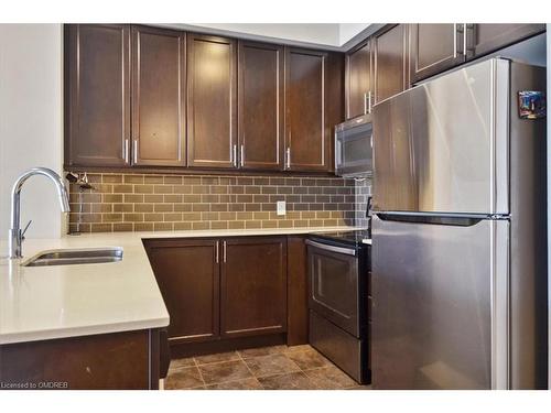 523-2480 Prince Michael Drive, Oakville, ON - Indoor Photo Showing Kitchen With Stainless Steel Kitchen With Double Sink