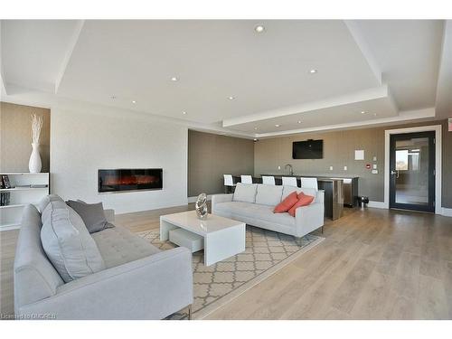 311-128 Garden Drive, Oakville, ON - Indoor Photo Showing Living Room With Fireplace