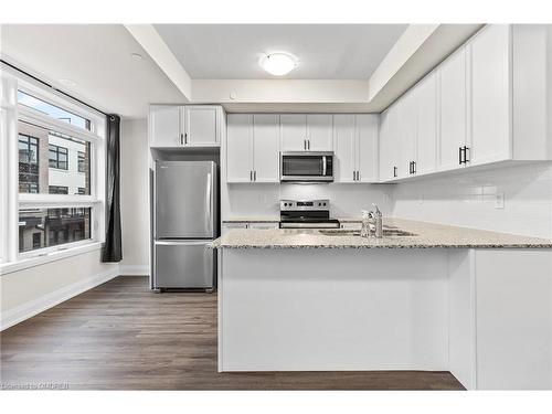 117-1569 Rose Way, Milton, ON - Indoor Photo Showing Kitchen With Stainless Steel Kitchen With Double Sink With Upgraded Kitchen