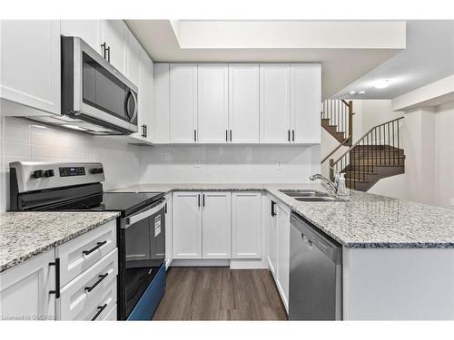 117-1569 Rose Way, Milton, ON - Indoor Photo Showing Kitchen With Stainless Steel Kitchen With Double Sink With Upgraded Kitchen