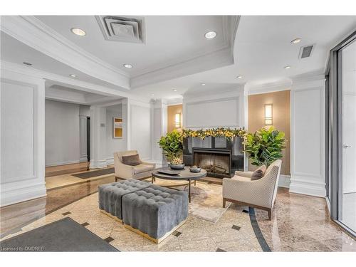 102-16 Dallimore Circle, Toronto, ON - Indoor Photo Showing Living Room With Fireplace