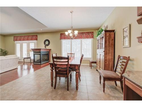 32-260 Deer Ridge Drive, Kitchener, ON - Indoor Photo Showing Dining Room With Fireplace