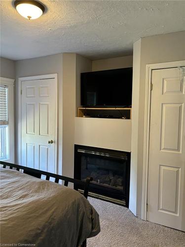 25 John Street, Cambridge, ON - Indoor Photo Showing Bedroom With Fireplace