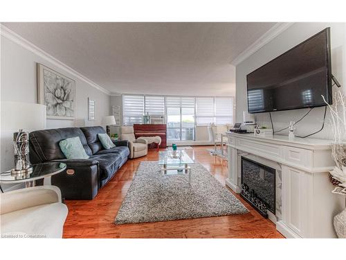 801-65 Westmount Street N, Waterloo, ON - Indoor Photo Showing Living Room With Fireplace