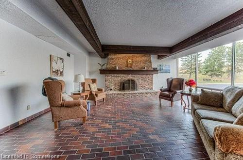 810-225 Harvard Place, Waterloo, ON - Indoor Photo Showing Living Room With Fireplace