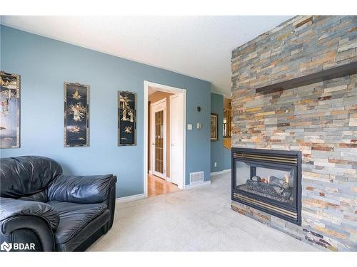 36 Marlow Circle, Springwater, ON - Indoor Photo Showing Living Room With Fireplace