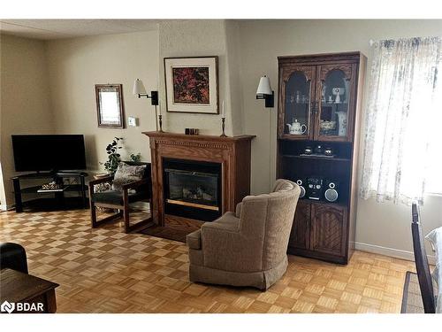 103-54 Fittons Road W, Orillia, ON - Indoor Photo Showing Living Room With Fireplace