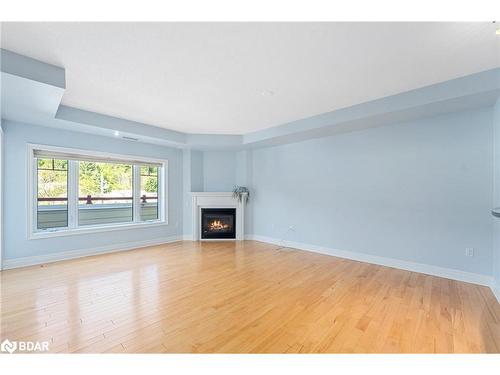 208-110 Steamship Bay, Gravenhurst, ON - Indoor Photo Showing Other Room With Fireplace