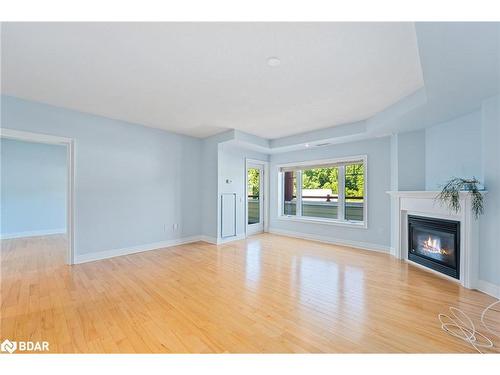 208-110 Steamship Bay, Gravenhurst, ON - Indoor Photo Showing Living Room With Fireplace