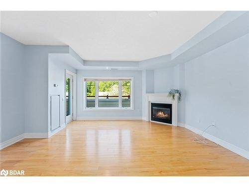 208-110 Steamship Bay, Gravenhurst, ON - Indoor Photo Showing Living Room With Fireplace