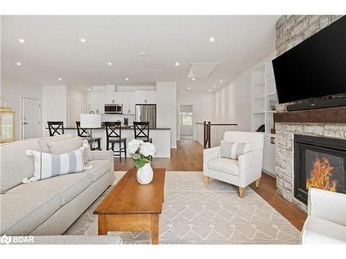 A203/204-1869 Highway 118 Road W, Bracebridge, ON - Indoor Photo Showing Living Room With Fireplace