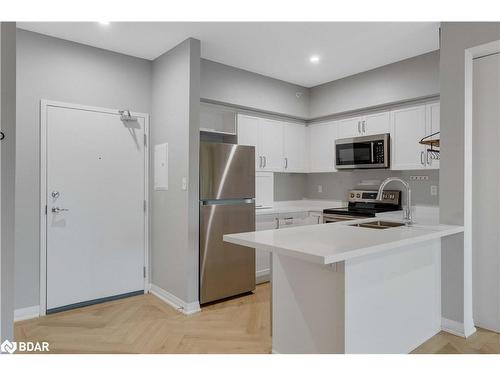 406-295 Cundles Road E, Barrie, ON - Indoor Photo Showing Kitchen With Stainless Steel Kitchen With Double Sink