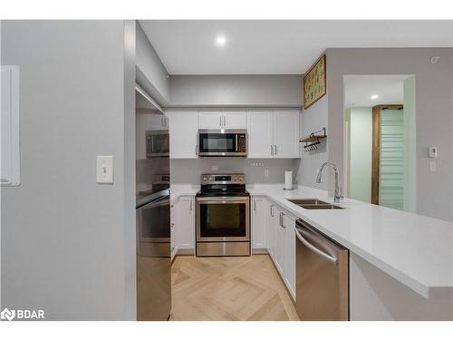 406-295 Cundles Road E, Barrie, ON - Indoor Photo Showing Kitchen With Stainless Steel Kitchen With Double Sink With Upgraded Kitchen