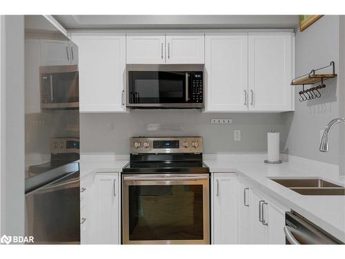 406-295 Cundles Road E, Barrie, ON - Indoor Photo Showing Kitchen With Stainless Steel Kitchen With Double Sink