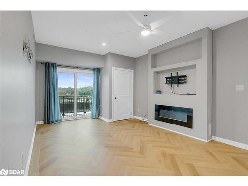 406-295 Cundles Road E, Barrie, ON - Indoor Photo Showing Living Room With Fireplace