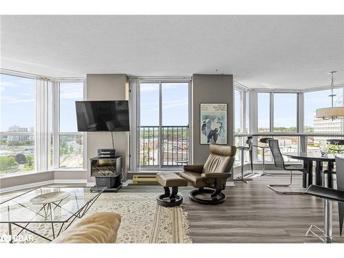 906-140 Dunlop Street E, Barrie, ON - Indoor Photo Showing Living Room With Fireplace