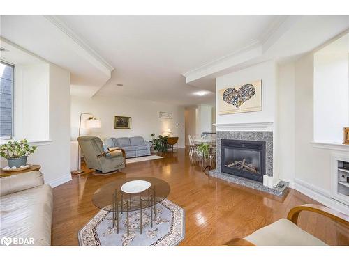 401-200 Collier Street, Barrie, ON - Indoor Photo Showing Living Room With Fireplace