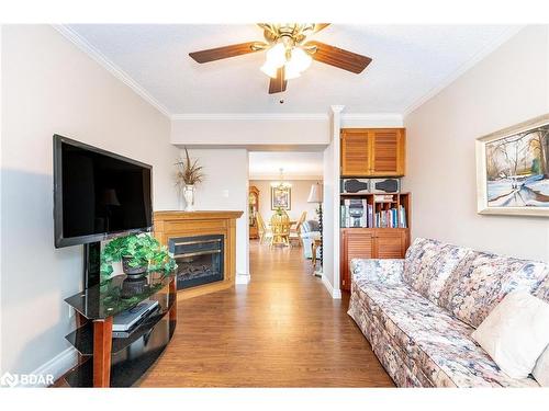 801-181 Collier Street, Barrie, ON - Indoor Photo Showing Living Room With Fireplace