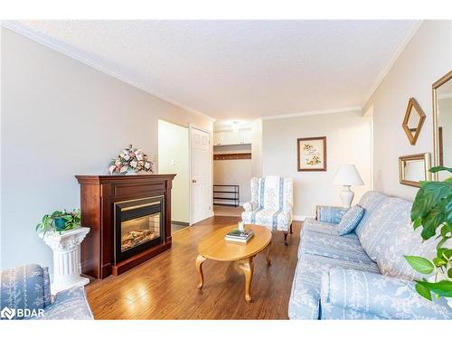 801-181 Collier Street, Barrie, ON - Indoor Photo Showing Living Room With Fireplace