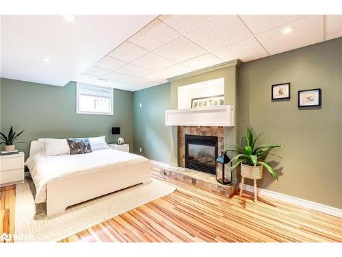 39 Saint Laurent Boulevard, Tiny, ON - Indoor Photo Showing Bedroom With Fireplace