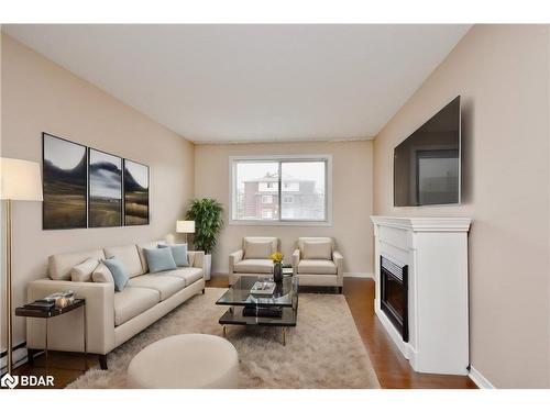 103-25 Meadow Lane, Barrie, ON - Indoor Photo Showing Living Room With Fireplace