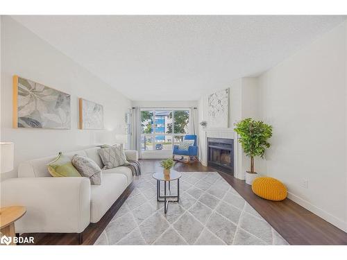 214-126 Bell Farm Road, Barrie, ON - Indoor Photo Showing Living Room With Fireplace