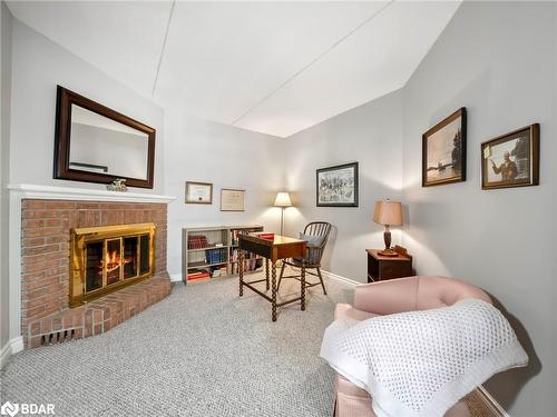 107-330 Brewery Lane, Orillia, ON - Indoor Photo Showing Bedroom With Fireplace