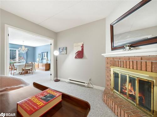 107-330 Brewery Lane, Orillia, ON - Indoor Photo Showing Living Room With Fireplace