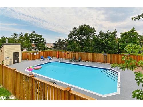 1013-6720 Glen Erin Drive, Mississauga, ON - Outdoor With In Ground Pool With Backyard