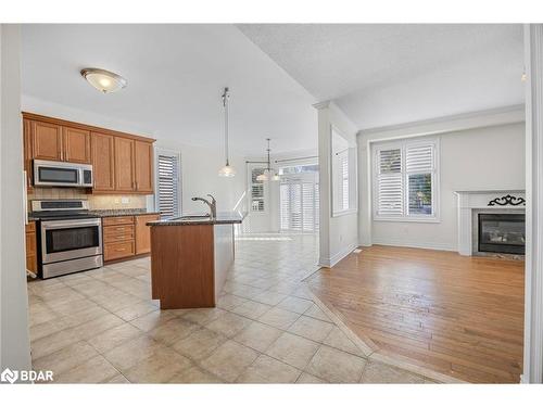 33 Collier Crescent, Angus, ON - Indoor Photo Showing Kitchen With Fireplace