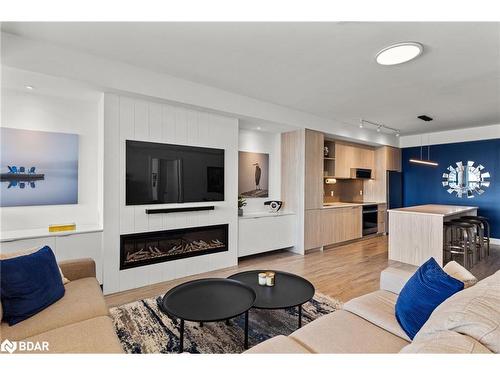 306-185 Dunlop Street E, Barrie, ON - Indoor Photo Showing Living Room With Fireplace