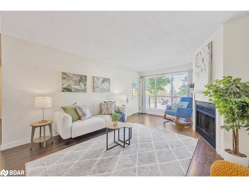 214-126 Bell Farm Road, Barrie, ON - Indoor Photo Showing Living Room With Fireplace