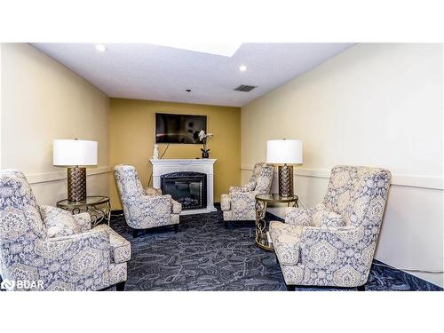 1401-150 Dunlop Street E, Barrie, ON - Indoor Photo Showing Living Room With Fireplace