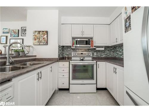 711-150 Dunlop Street E, Barrie, ON - Indoor Photo Showing Kitchen With Double Sink