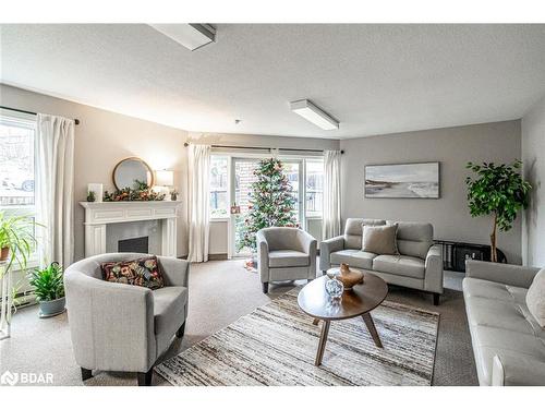 303-131 Clapperton Street, Barrie, ON - Indoor Photo Showing Living Room With Fireplace