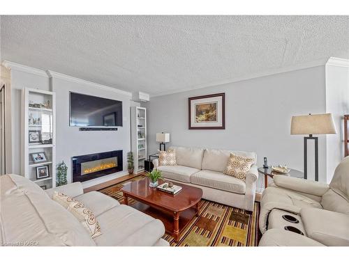 710-675 Davis Drive, Kingston, ON - Indoor Photo Showing Living Room With Fireplace