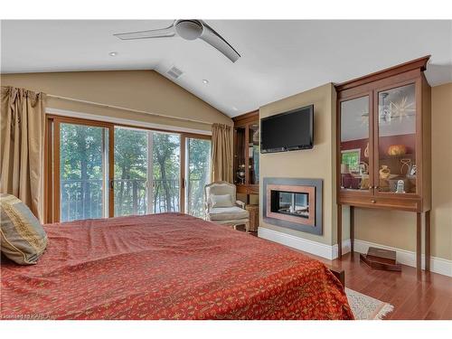 7955 Perth Road, South Frontenac, ON - Indoor Photo Showing Bedroom With Fireplace