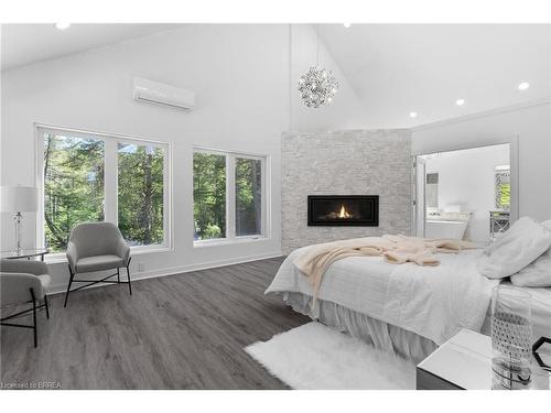 1814 Riding Ranch Road, South River, ON - Indoor Photo Showing Bedroom With Fireplace