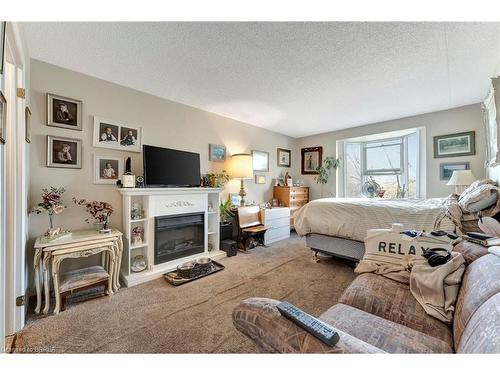 305-88 Tollgate Road, Brantford, ON - Indoor Photo Showing Bedroom With Fireplace