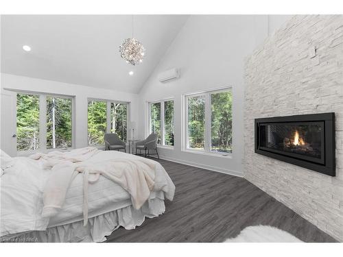 1814 Riding Ranch Road, South River, ON - Indoor Photo Showing Bedroom With Fireplace