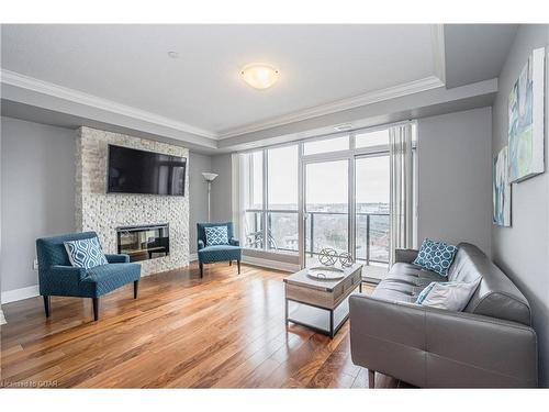 901-150 Wellington Street E, Guelph, ON - Indoor Photo Showing Living Room With Fireplace