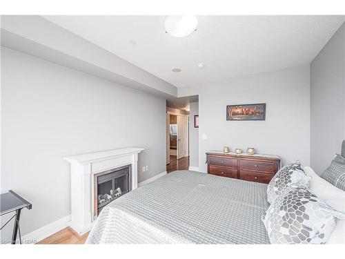 901-150 Wellington Street E, Guelph, ON - Indoor Photo Showing Bedroom With Fireplace