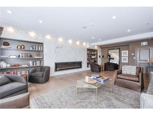 901-150 Wellington Street E, Guelph, ON - Indoor Photo Showing Living Room With Fireplace