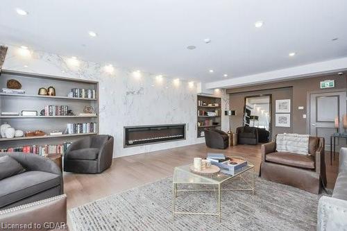 1305-150 Wellington Street E, Guelph, ON - Indoor Photo Showing Living Room With Fireplace