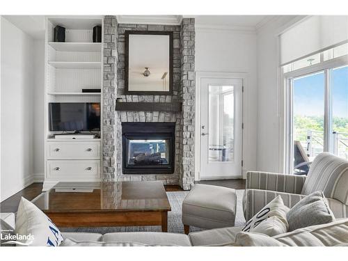 T202 (B2/C1)-1869 Muskoka Road 118 W, Muskoka Lakes, ON - Indoor Photo Showing Living Room With Fireplace